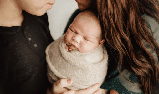 couple holding newborn baby