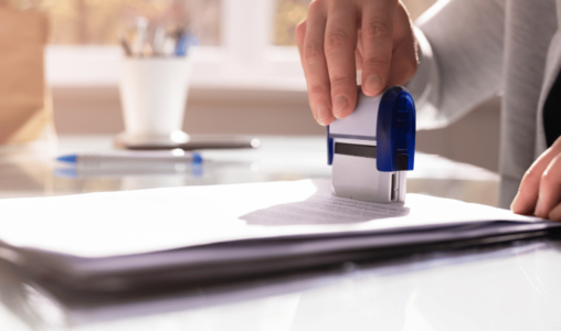 Person stamping paper