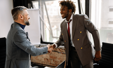 two men in suits shaking hands
