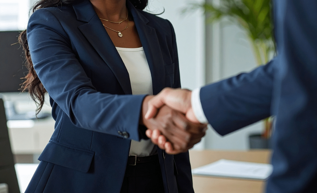 businesswoman and businessman shake hands