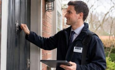 outside salesman knocking on front door