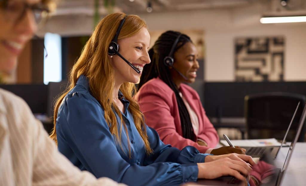 3 inside sales reps working sales as a service at their work laptops
