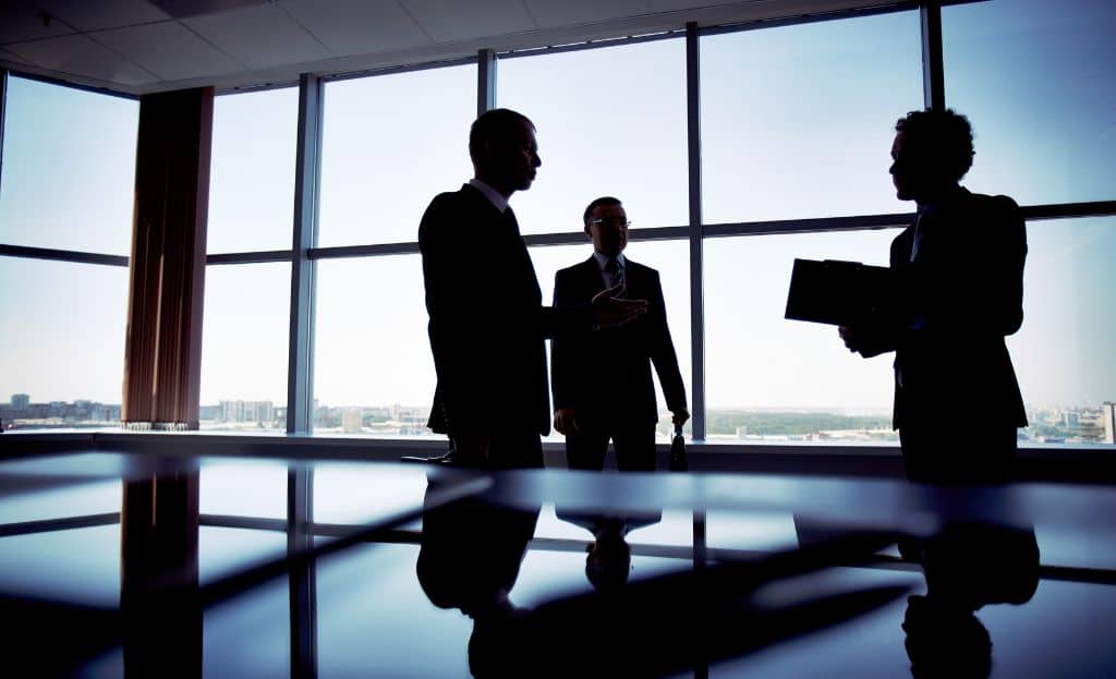 business people discussing the cost of entering the US market